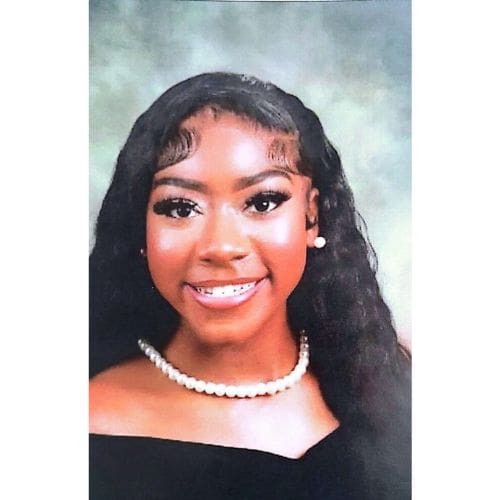 Smiling young woman portrait wearing pearl necklace