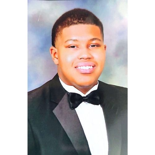 Smiling person in black tuxedo portrait