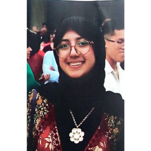Smiling woman wearing hijab and glasses