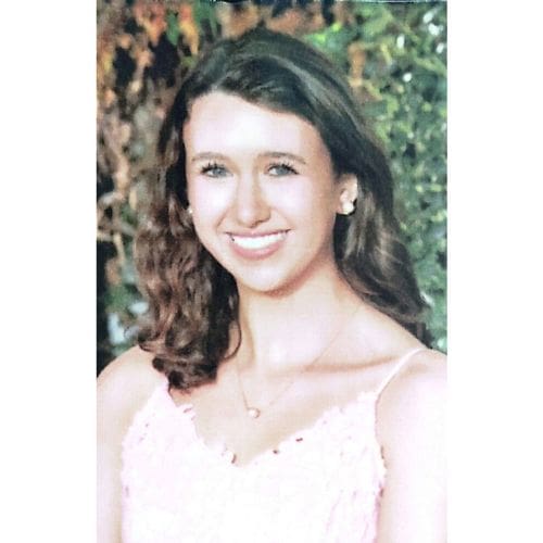 Portrait of smiling young woman in pink dress