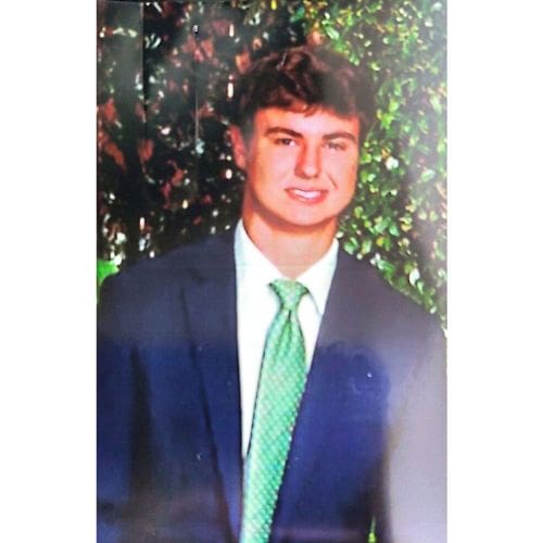 Person in suit with green tie