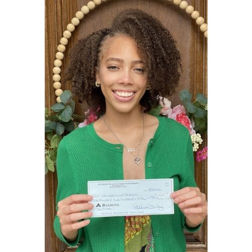 Smiling woman holding a check