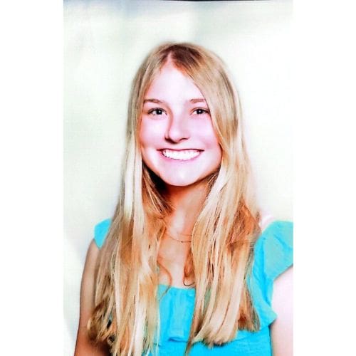 Headshot of smiling woman in turquoise top