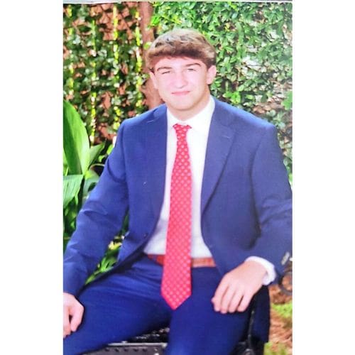 Young man in blue suit and red tie
